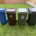 general waste wheelie bin, plus four recycling bins lined up