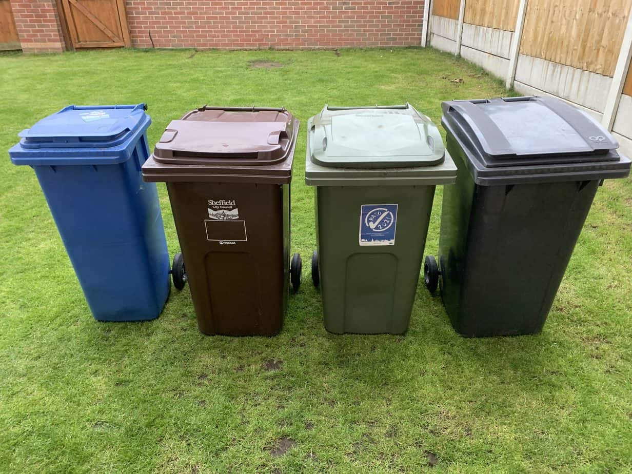 general waste wheelie bin, plus four recycling bins lined up