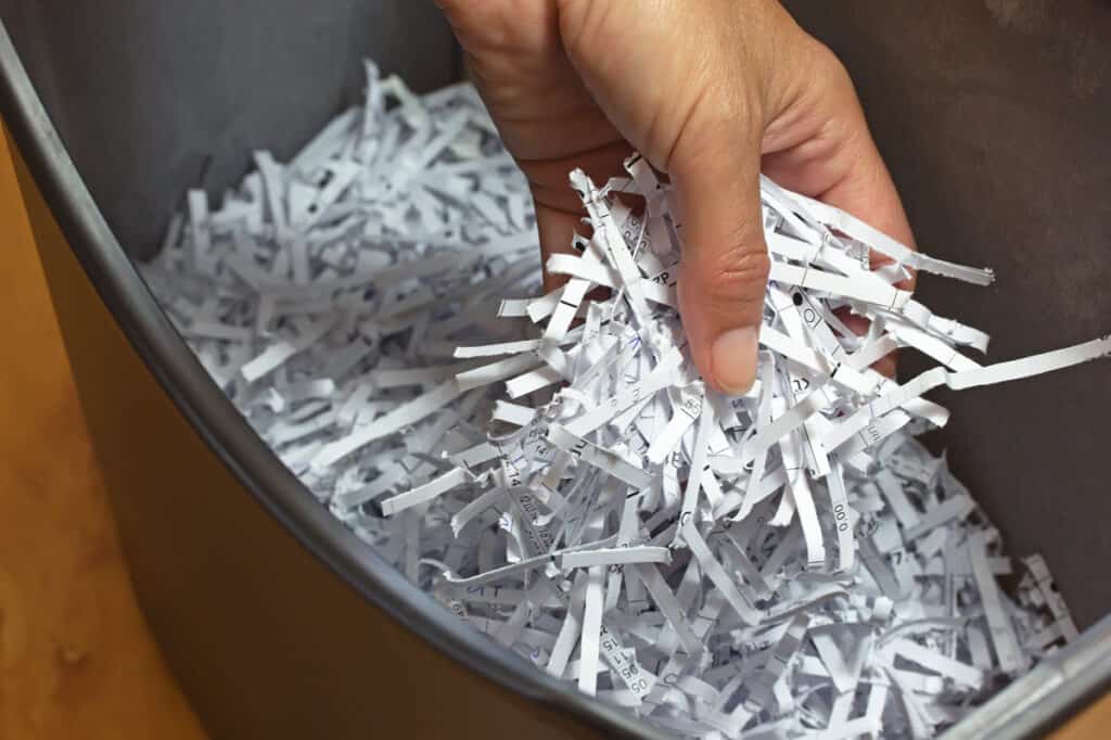 shredded paper in shredder basket