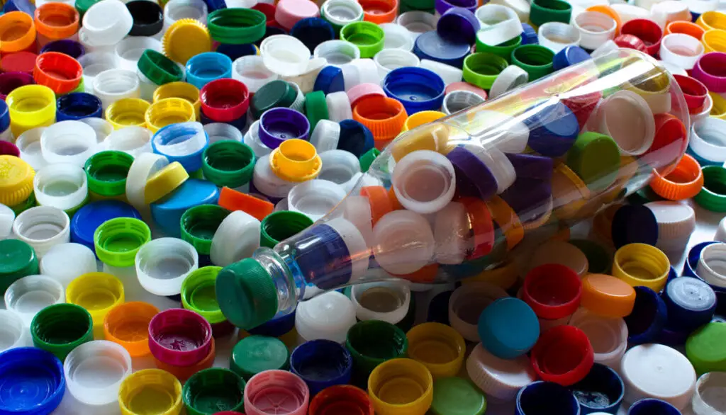 bottle and large collection of assorted plastic lids