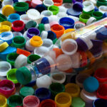 bottle and large collection of assorted plastic lids