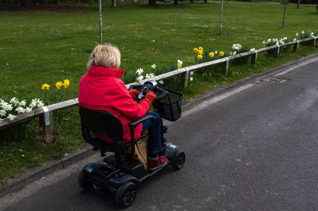 lady using mobility scooter in park