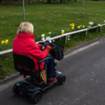 lady using mobility scooter in park