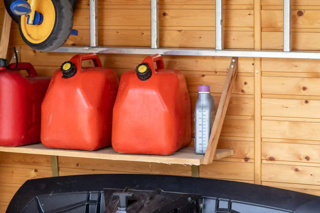 petrol cans on shelf in garage